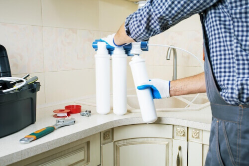 a person holding a water filter